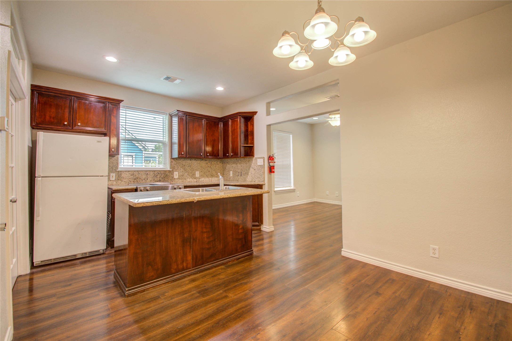 2119 Kane Street Houston, TX 77007 - Photo 18 of 29 a kitchen with stainless steel appliances granite countertop a refrigerator a stove a sink and a refrigerator with wooden floor