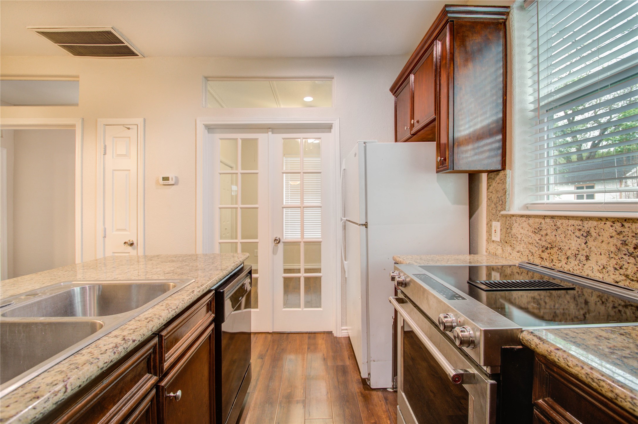 2119 Kane Street Houston, TX 77007 - Photo 20 of 29 a kitchen that has a sink a stove and a window