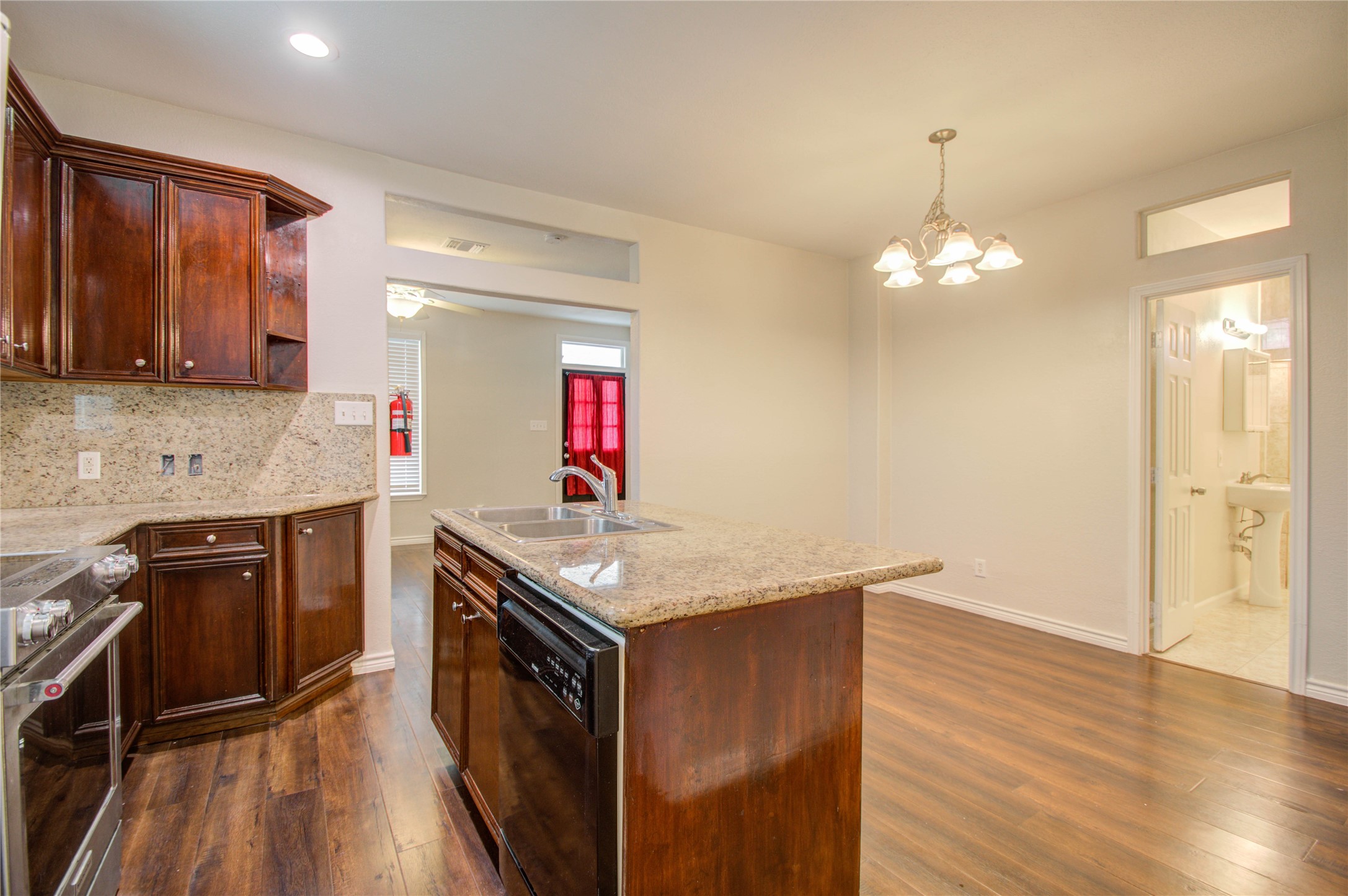 2119 Kane Street Houston, TX 77007 - Photo 21 of 29 a kitchen with granite countertop a sink cabinets and wooden floor