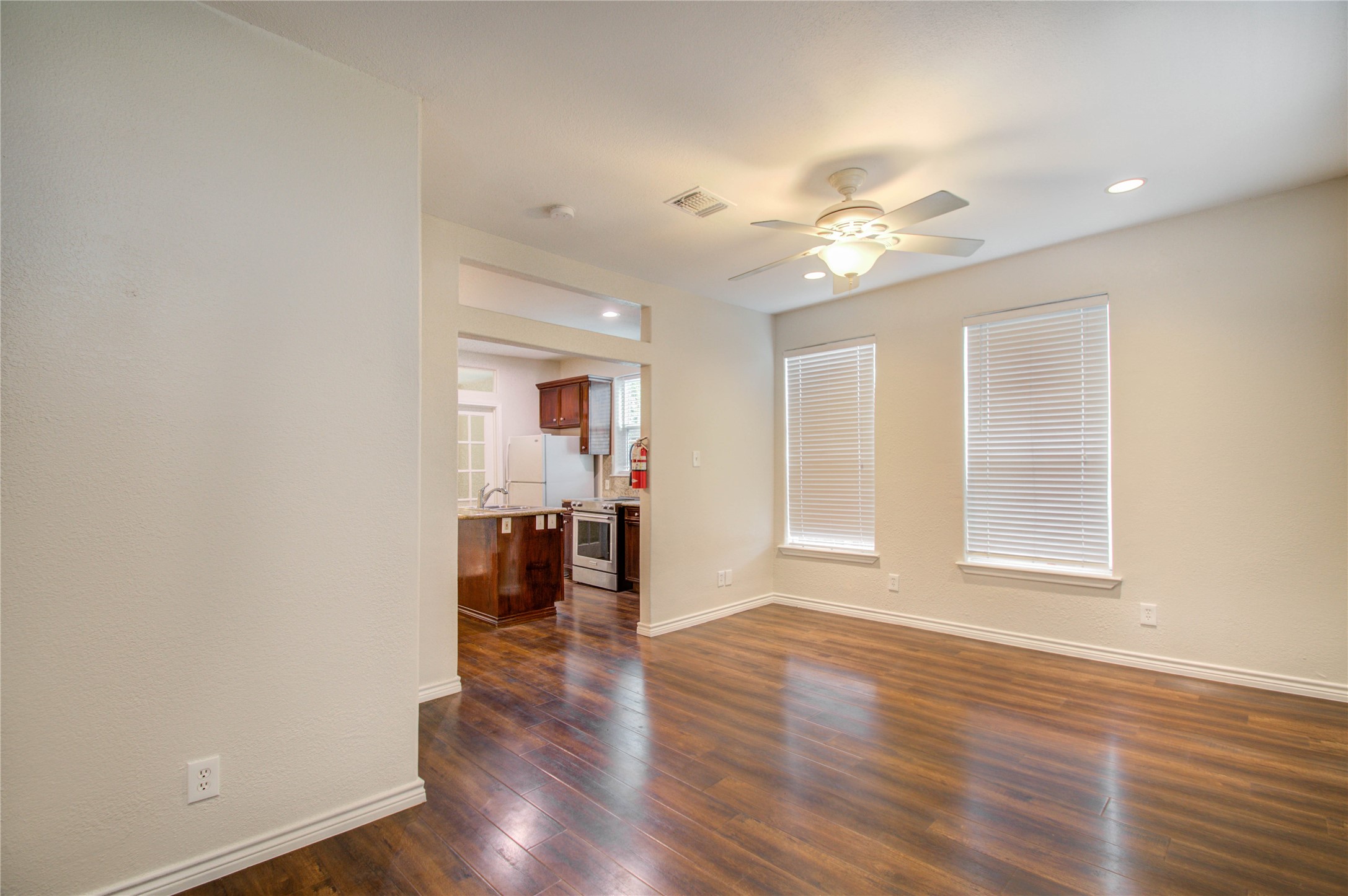 2119 Kane Street Houston, TX 77007 - Photo 23 of 29 a view of a livingroom with furniture wooden floor and a ceiling fan