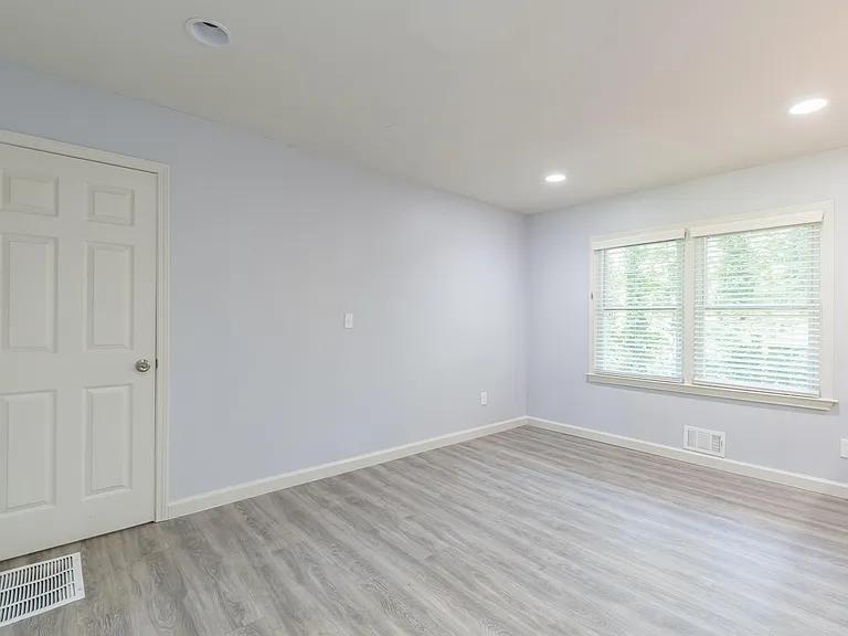 2077 Green Forrest Drive Decatur, GA 30032 - Photo 15 of 21 wooden floor in an empty room with a window