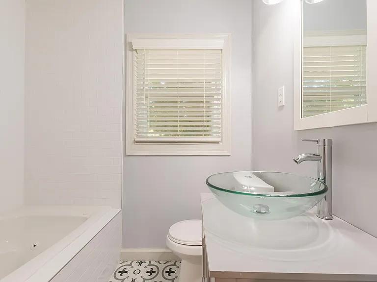 2077 Green Forrest Drive Decatur, GA 30032 - Photo 20 of 21 a bathroom with a granite countertop toilet a sink and bathtub
