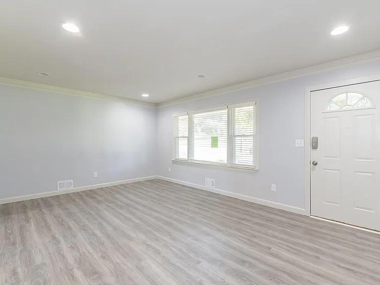 2077 Green Forrest Drive Decatur, GA 30032 - Photo 4 of 21 an empty room with wooden floor and windows