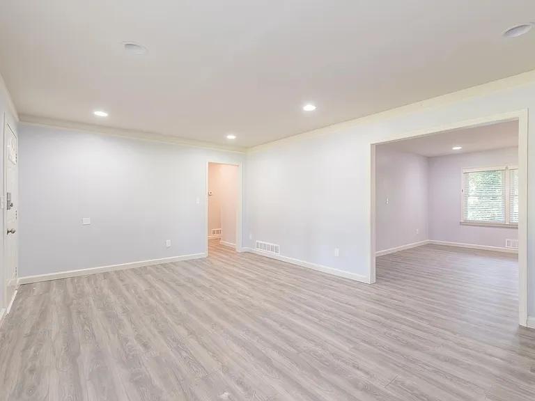 2077 Green Forrest Drive Decatur, GA 30032 - Photo 6 of 21 an empty room with wooden floor and windows