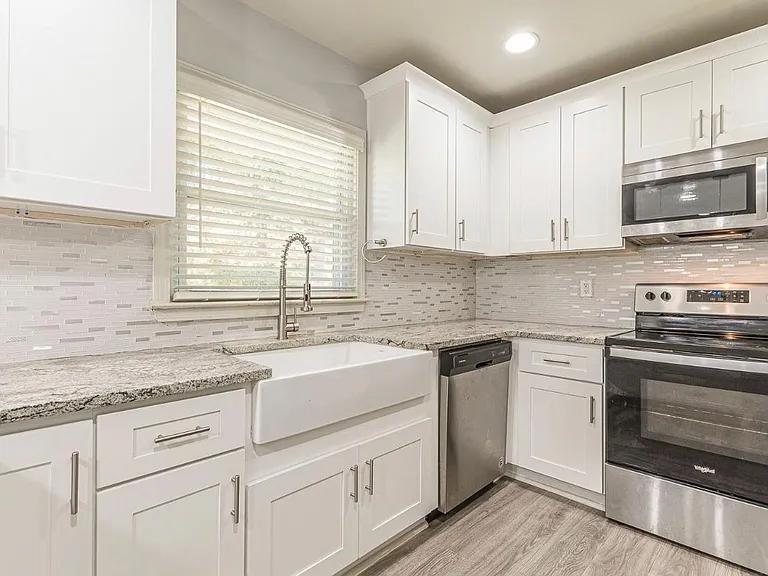2077 Green Forrest Drive Decatur, GA 30032 - Photo 8 of 21 a kitchen with stainless steel appliances granite countertop white cabinets sink and a oven