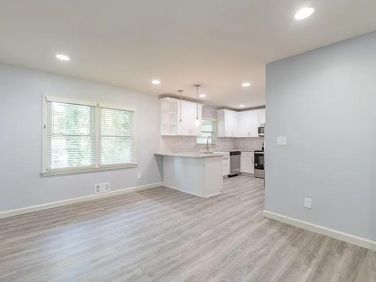 2077 Green Forrest Drive Decatur, GA 30032 - Photo 9 of 21 a open kitchen with white cabinets and wooden floor