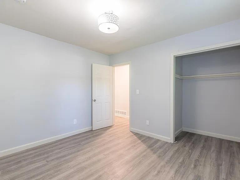 2077 Green Forrest Drive Decatur, GA 30032 - Photo 10 of 21 an empty room with wooden floor and windows