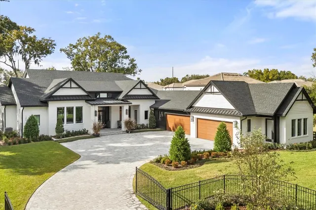 a front view of a house with a garden and plants