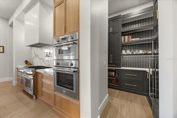 a kitchen with stainless steel appliances granite countertop a sink and a refrigerator