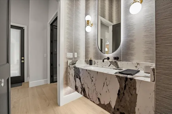 a bathroom with a tub a sink and a mirror