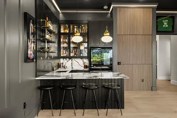 a large white kitchen with a sink and dishwasher a refrigerator with white cabinets