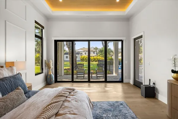 a living room with furniture a chandelier and a flat screen tv