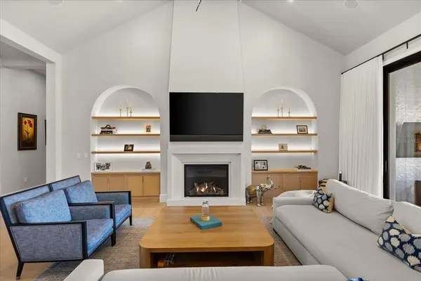 a living room with furniture a fireplace and a flat screen tv