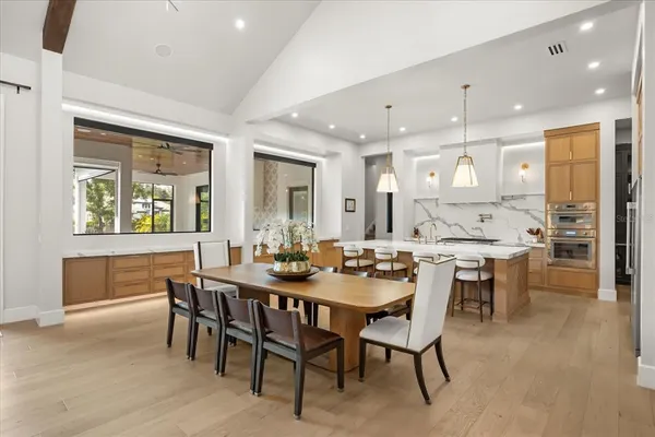 a kitchen with stainless steel appliances granite countertop a sink a stove and a refrigerator