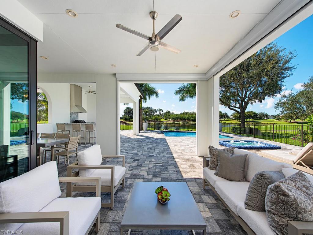 16868 Brightling Way Naples, FL 34110 - Photo 12 of 35 a living room with patio furniture and a large window