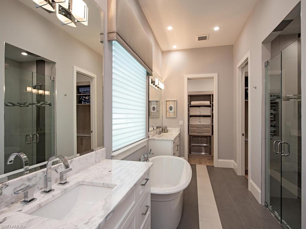 16868 Brightling Way Naples, FL 34110 - Photo 16 of 35 a bathroom with a sink a toilet and shower