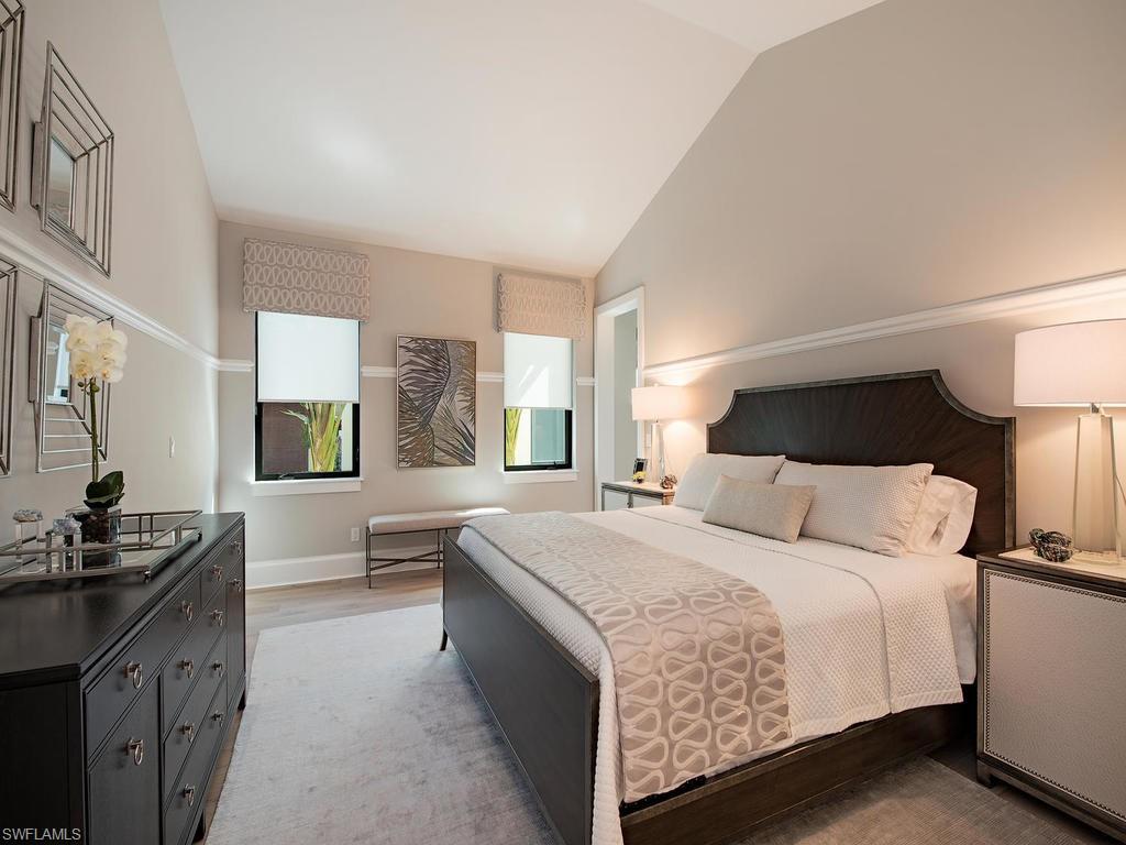 16868 Brightling Way Naples, FL 34110 - Photo 17 of 35 a bedroom with a bed and wooden floor
