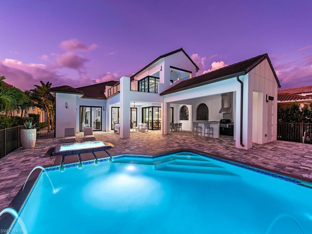 16868 Brightling Way Naples, FL 34110 - Photo 2 of 35 a front view of a house with swimming pool having outdoor seating