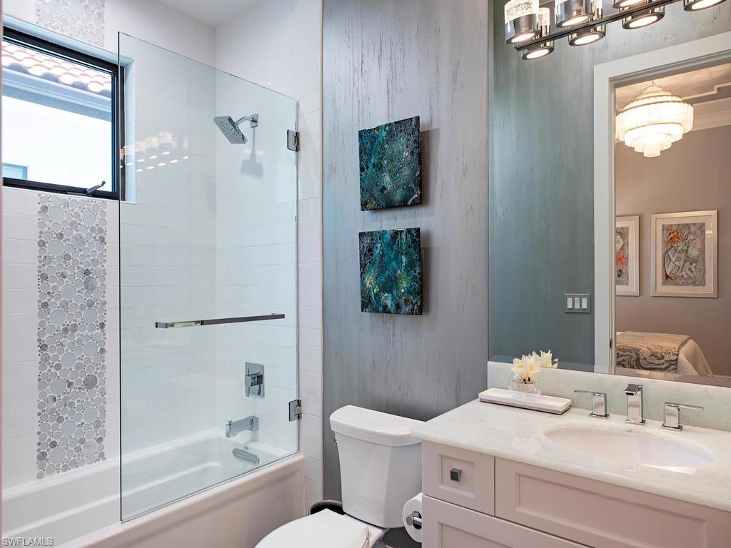 16868 Brightling Way Naples, FL 34110 - Photo 21 of 35 a bathroom with a sink a toilet and shower