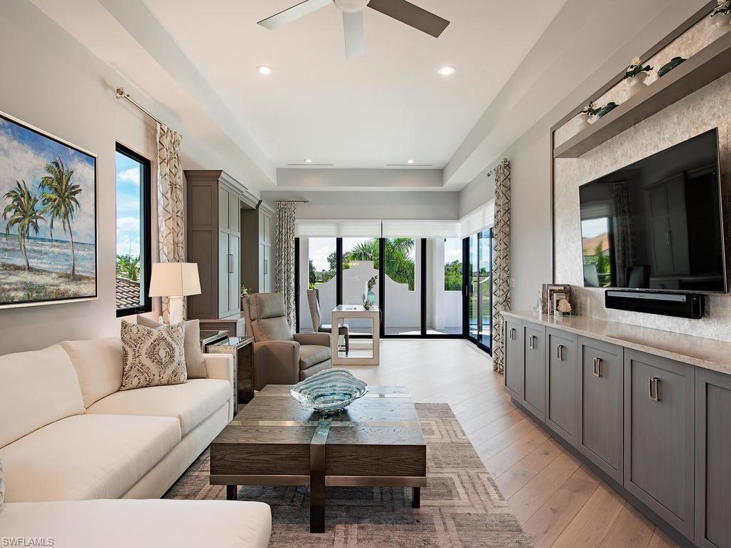 16868 Brightling Way Naples, FL 34110 - Photo 24 of 35 a living room with furniture flat screen tv and a large window