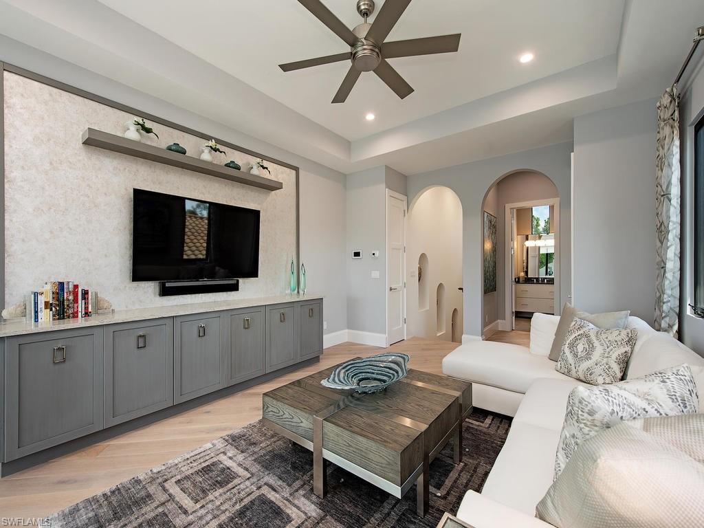 16868 Brightling Way Naples, FL 34110 - Photo 25 of 35 a living room with furniture and a flat screen tv