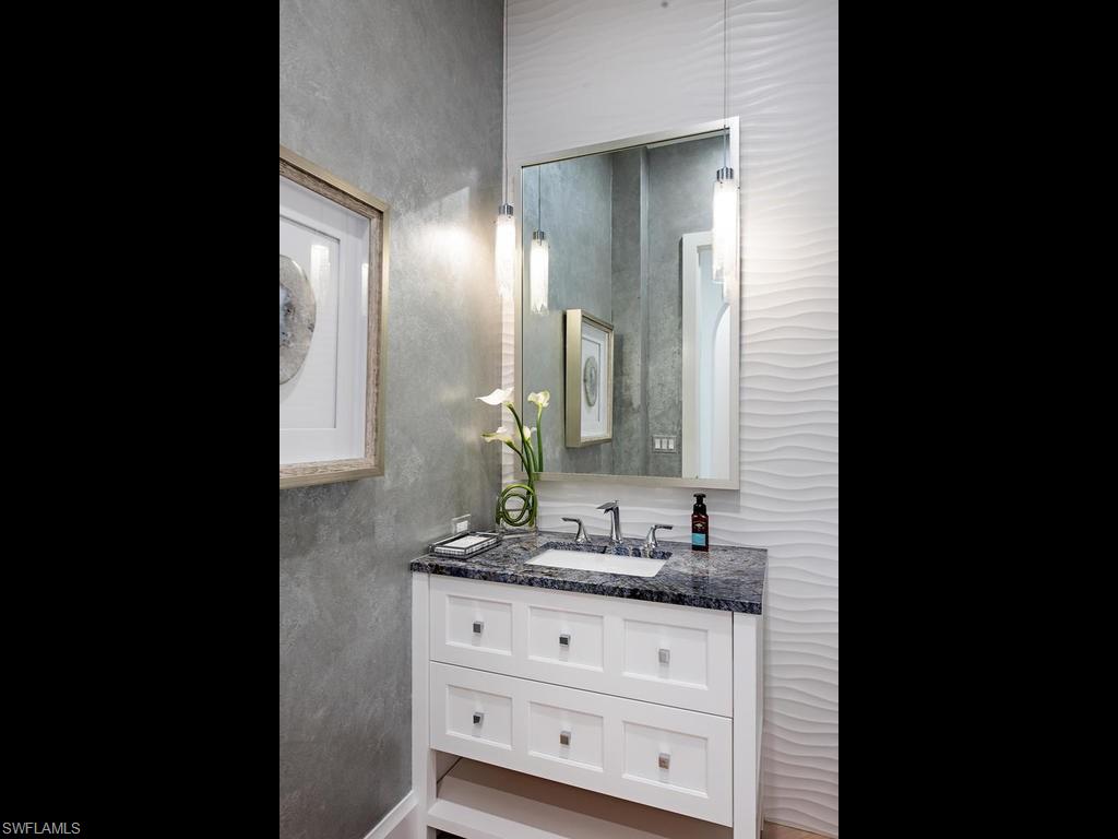 16868 Brightling Way Naples, FL 34110 - Photo 26 of 35 a bathroom with a sink and a mirror