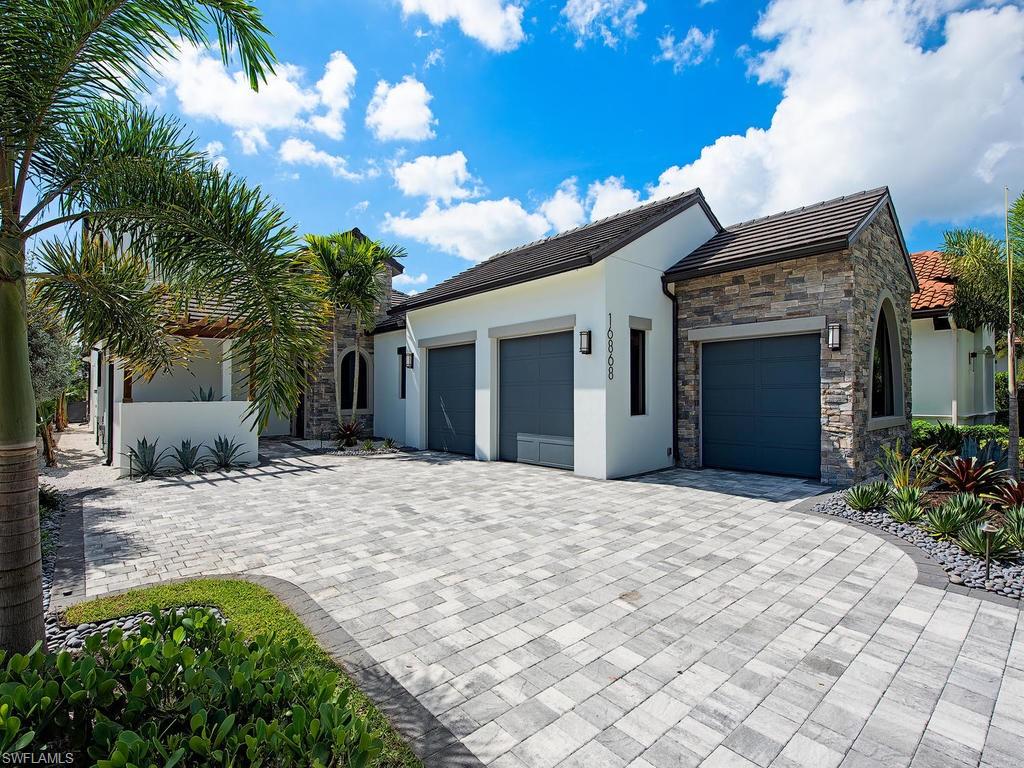 16868 Brightling Way Naples, FL 34110 - Photo 34 of 35 a front view of a house with a yard and a garage