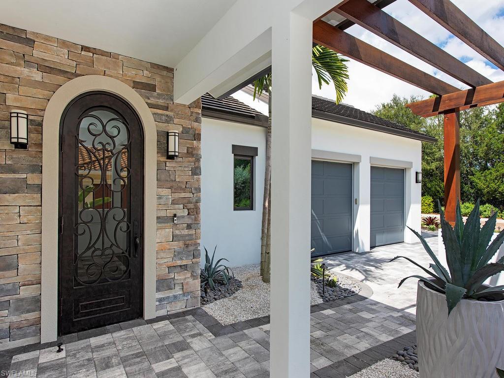 16868 Brightling Way Naples, FL 34110 - Photo 35 of 35 a front view of a house with garden