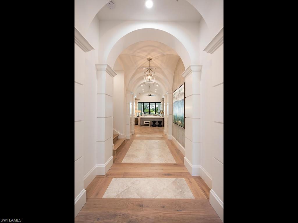 16868 Brightling Way Naples, FL 34110 - Photo 4 of 35 a view of a hallway to a livingroom with furniture window and front door