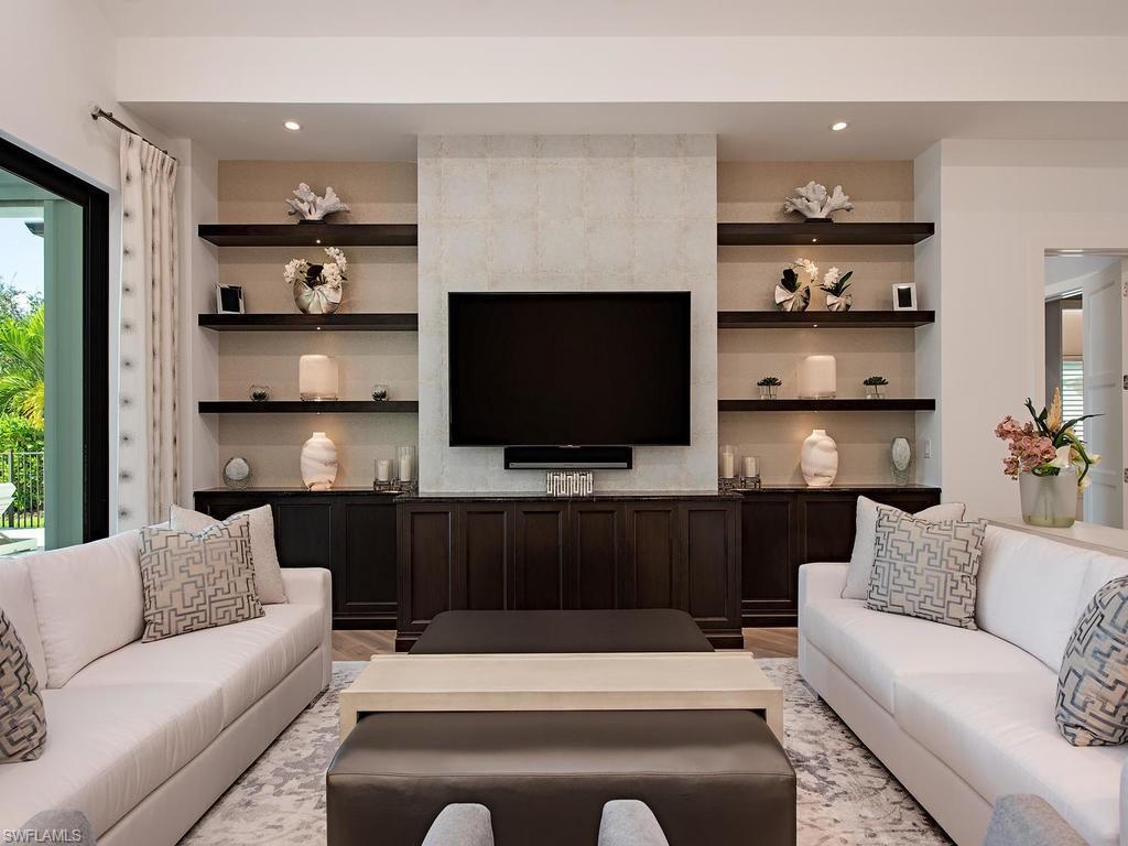 16868 Brightling Way Naples, FL 34110 - Photo 8 of 35 a living room with furniture and a flat screen tv