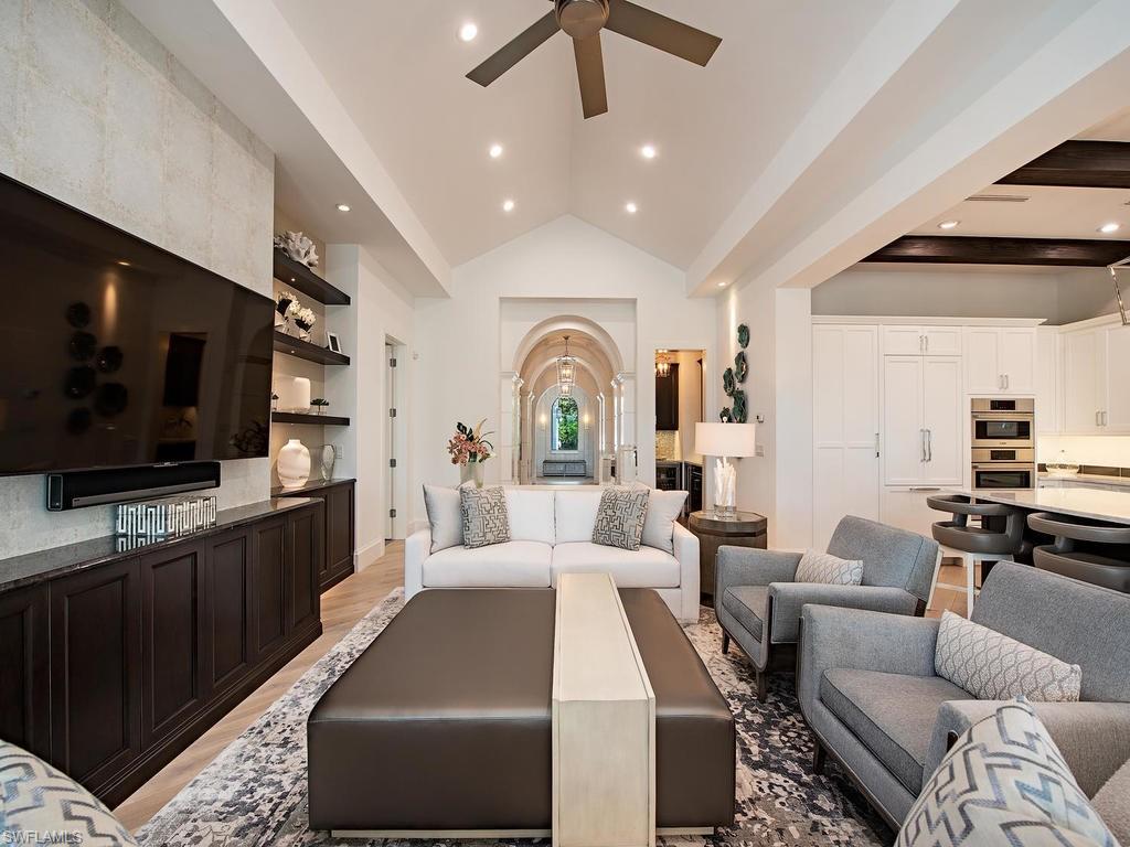 16868 Brightling Way Naples, FL 34110 - Photo 9 of 35 a living room with furniture and a flat screen tv