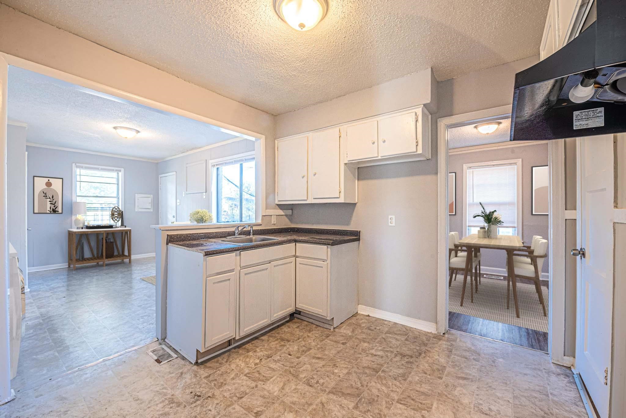 1109 Getwell Road Memphis, TN 38111 - Photo 11 of 22 a kitchen with granite countertop cabinets a sink a window and stainless steel appliances