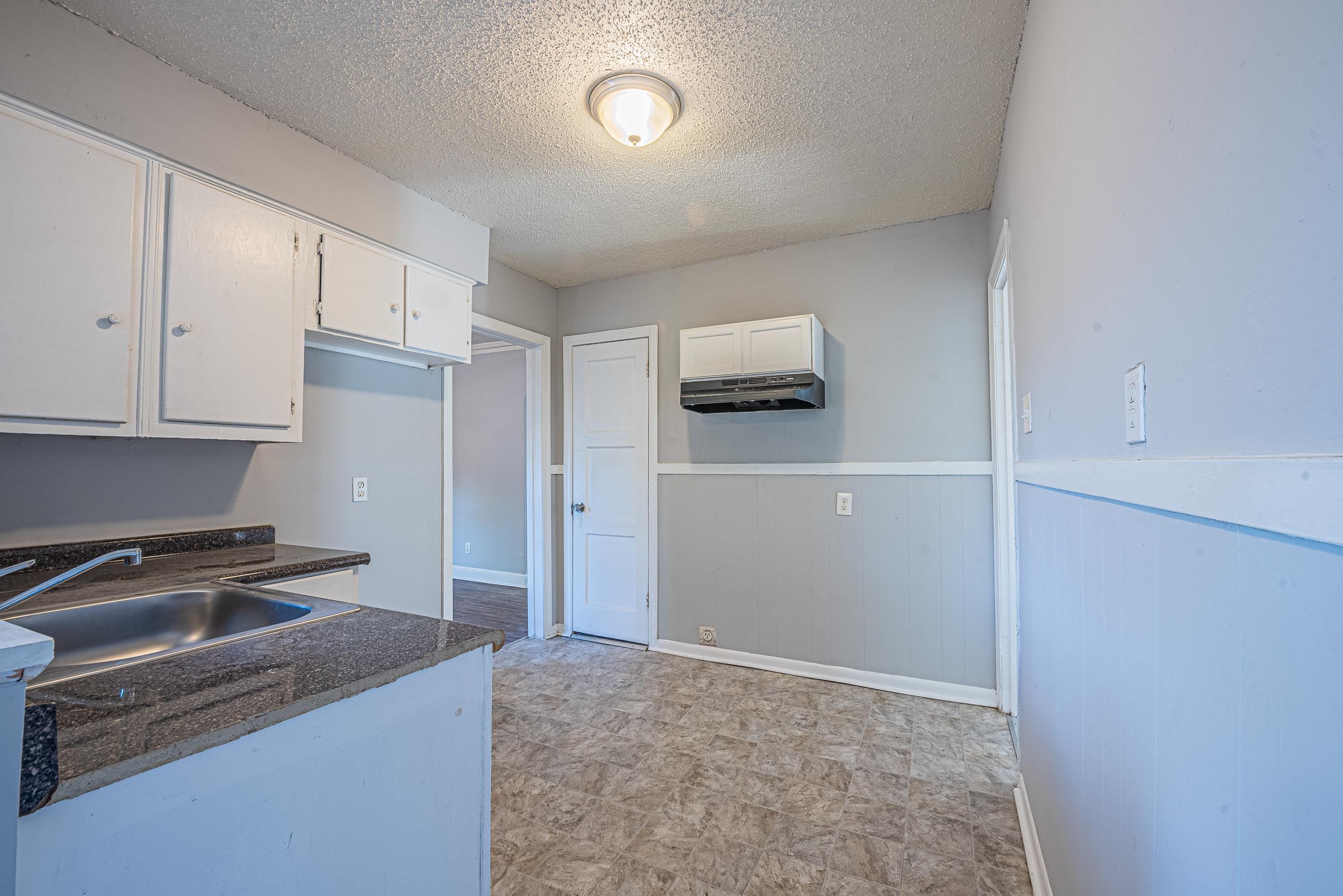 1109 Getwell Road Memphis, TN 38111 - Photo 12 of 22 a kitchen with kitchen island a refrigerator sink and stove