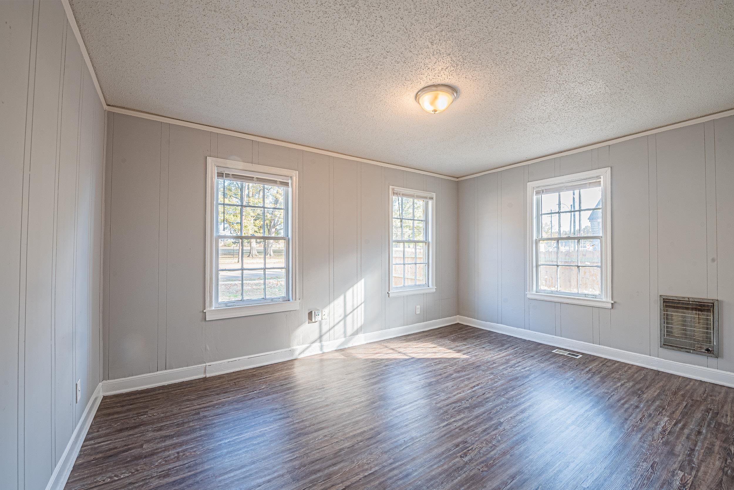 1109 Getwell Road Memphis, TN 38111 - Photo 18 of 22 an empty room with wooden floor and windows