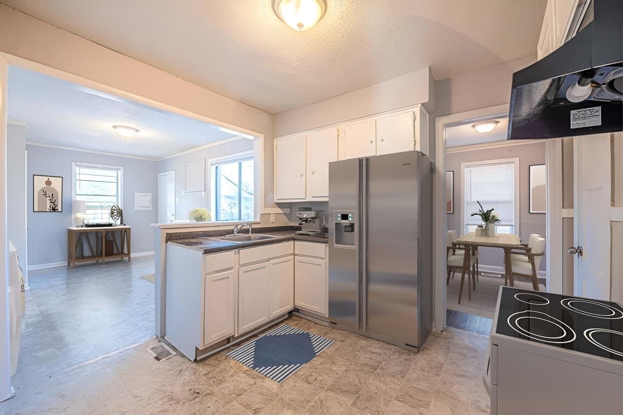 1109 Getwell Road Memphis, TN 38111 - Photo 8 of 22 a kitchen with stainless steel appliances granite countertop a refrigerator and a stove top oven