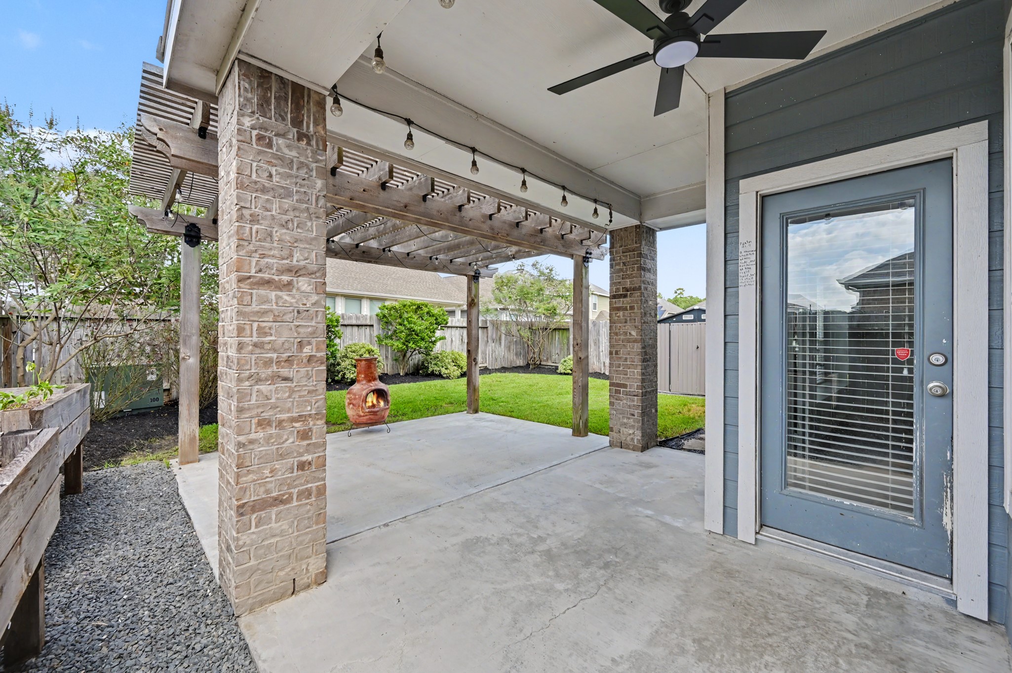29836 Woodsons Edge Way Spring, TX 77386 - Photo 28 of 38 The covered patio with fan and pergola extends the living space out back. Professional landscaping and separate storage shed.