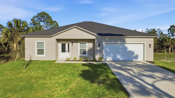 a front view of a house with a yard