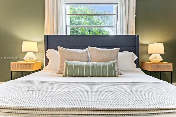 a bedroom with a bed and window
