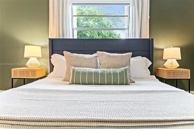 a bedroom with a bed and window