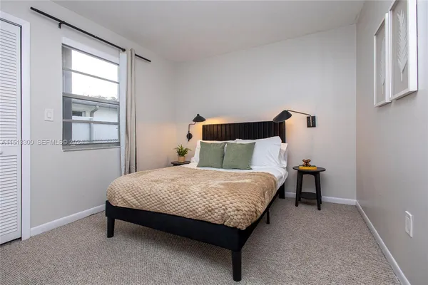 a bed sitting in a bedroom next to a window
