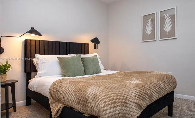 a bed sitting in a bedroom and lamp