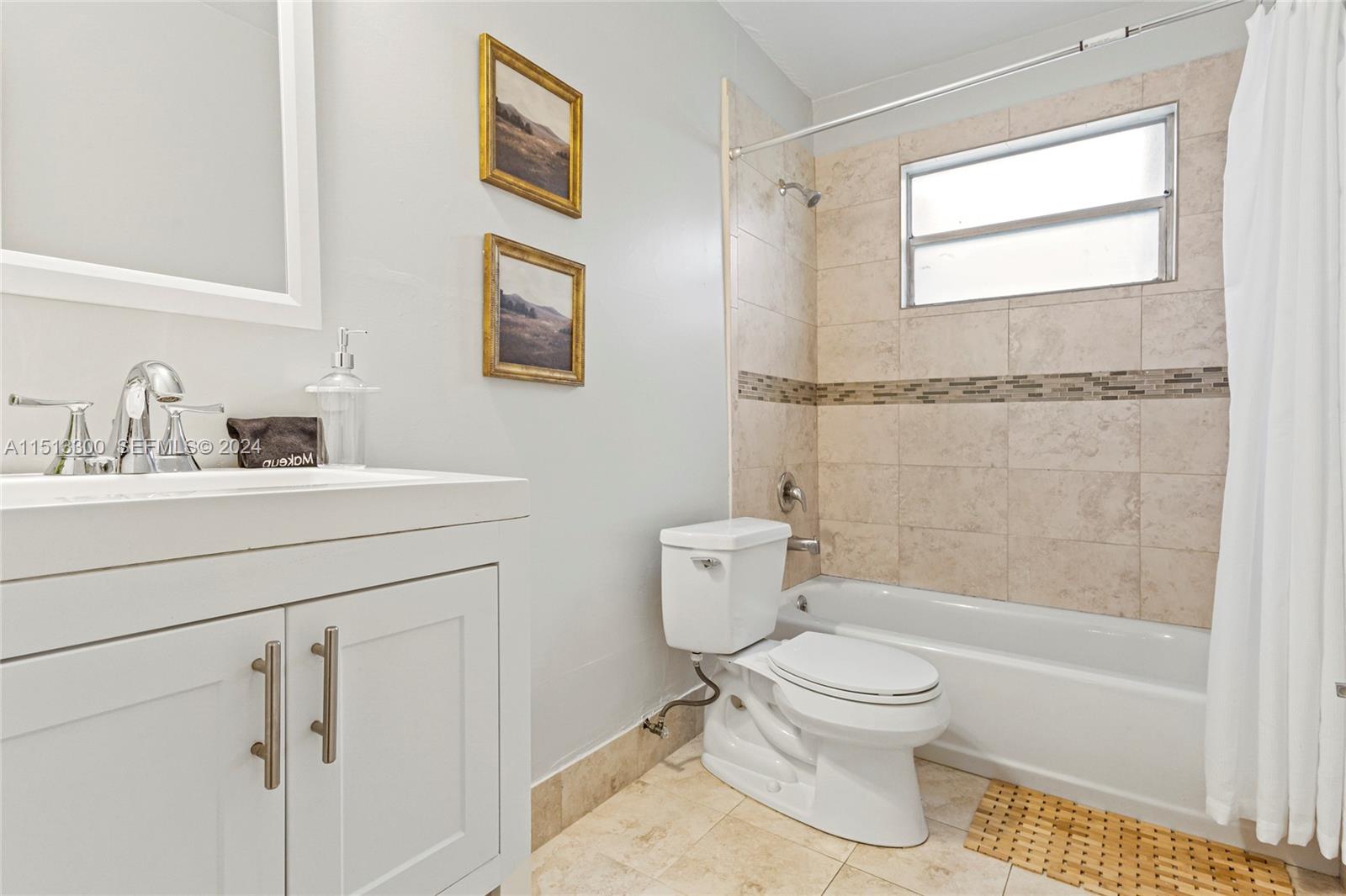 20075 Southwest 87th Place Cutler Bay, FL 33189 - Photo 23 of 32 a bathroom with a toilet sink vanity tub and shower