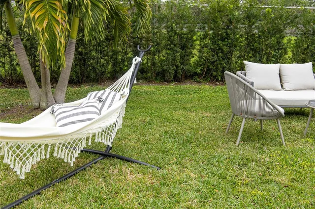 a view of a chair and table in the backyard