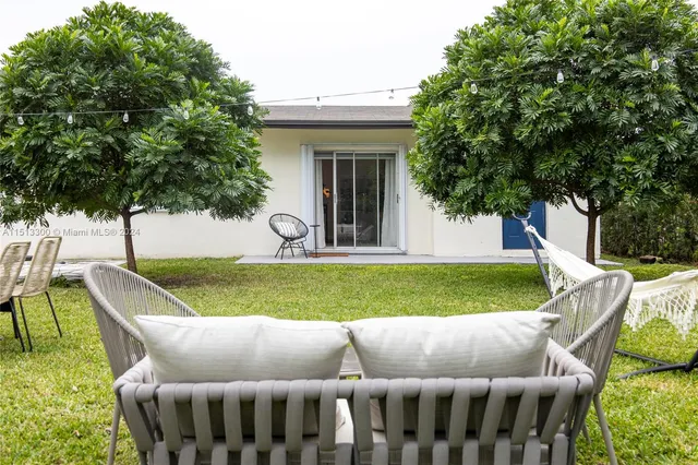 a view of house with backyard space and garden