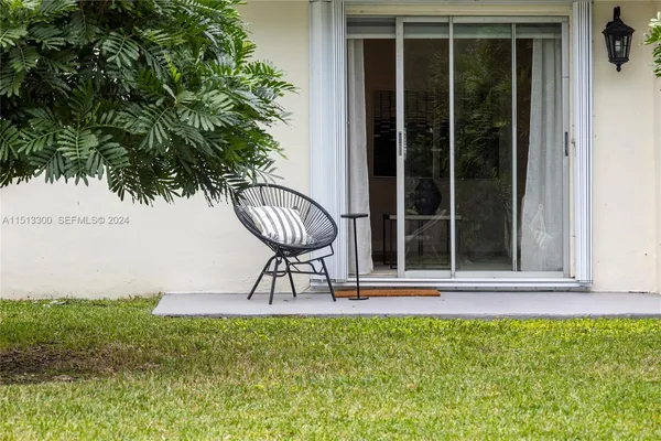 a view of a chairs and table in backyard