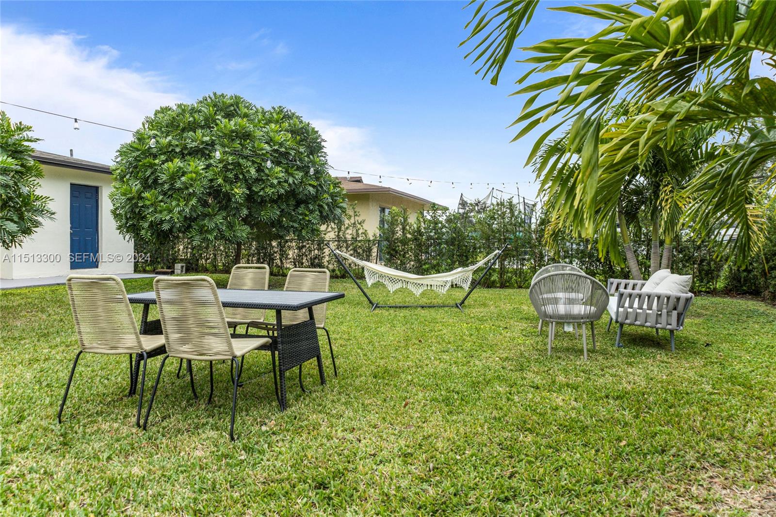 20075 Southwest 87th Place Cutler Bay, FL 33189 - Photo 31 of 32 a view of a chairs and table in backyard