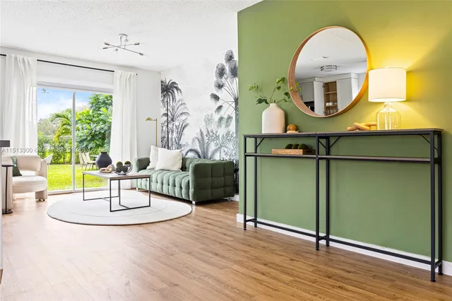 a living room with furniture and a mirror