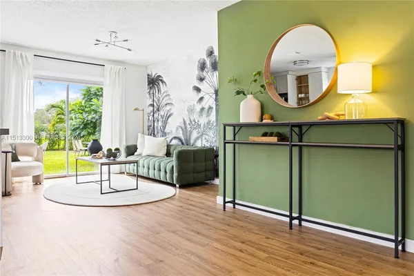 a living room with furniture and a mirror