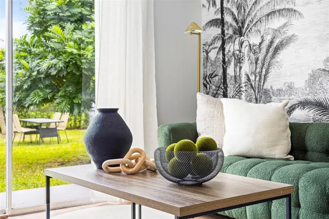 a living room with furniture and a potted plant