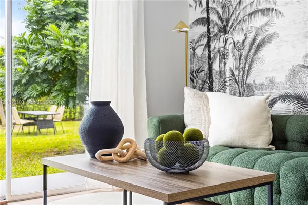 a living room with furniture and a potted plant